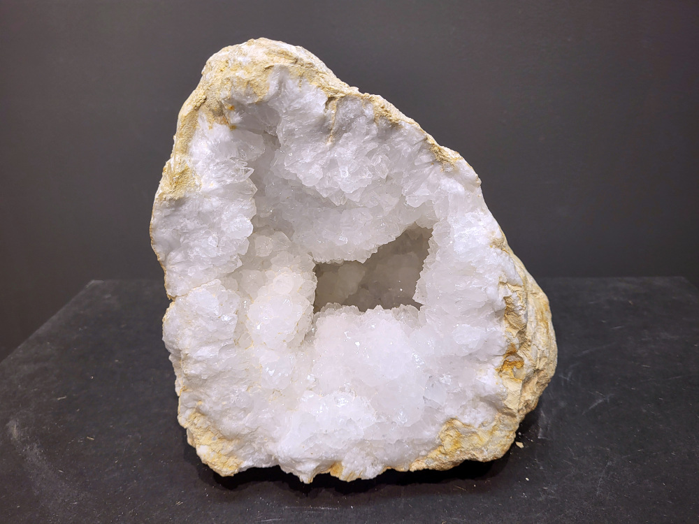Bergkristal, Geode, Cluster, 8,1kg, 95,- euro, nr. 32

Beschrijving Bergkristal.

Bergkristal is een heldere, kleurloze variëteit van kwarts en is een van de meest voorkomende edelstenen. Het staat bekend om zijn glasachtige glans en wordt gewaardeerd om zijn zuivere, krachtige energie en wordt vaak gebruikt in sieraden, meditatie en heling. 
Eigenschappen en gebruik:
Uiterlijk:
Bergkristal is meestal kleurloos en transparant, maar kan ook melkachtig wit zijn door insluitingen van lucht of water. 
Hardheid:
Het heeft een hardheid van 7 op de schaal van Mohs, wat betekent dat het vrij duurzaam is. 
Chemische samenstelling:
Bergkristal is siliciumdioxide (SiO2). 
Gebruik:
Sieraden: Het wordt vaak verwerkt in hangers, ringen, armbanden en andere sieraden. 
Meditatie en heling: Het wordt gebruikt om energie te zuiveren, te versterken en te balanceren, en wordt vaak ingezet bij meditaties en andere spirituele praktijken. 
Technologie: Kwarts, inclusief bergkristal, wordt gebruikt in elektronica vanwege zijn piezo-elektrische eigenschappen, zoals in quartz oscillatoren. 
Decoratie: Het wordt ook gebruikt voor decoratieve doeleinden, zoals beeldjes, stenen en andere ornamenten. 
Herkomst:
Bergkristal wordt op veel plaatsen in de wereld gevonden, zoals Brazilië, Madagaskar, de Himalaya en Zwitserland. 
Spirituele betekenis:
Zuivering en balans:
Bergkristal wordt vaak gezien als een steen die energieën zuivert en in balans brengt, zowel fysiek als energetisch. 
Heldere geest:
Het zou helderheid van geest bevorderen en helpen bij het loslaten van negatieve gedachten en emoties. 
Versterking van energie:
Bergkristal wordt vaak gebruikt om de energie van andere stenen te versterken. 
Bescherming:
In sommige culturen wordt bergkristal gezien als een beschermende steen die aura's beschermt tegen negatieve invloeden. 