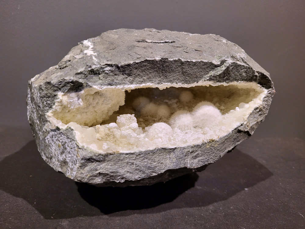 Okeniet, 5,6kg, 165,- euro, nr. 10
Okeniet bestaat uit hele fijne kristalletjes die eruit zien als bolletjes wol. Je krijgt de neiging om het even te willen aaien, maar doe dit niet want de kristallen zijn zeer kwetsbaar en zullen breken.
Vindplaats: India