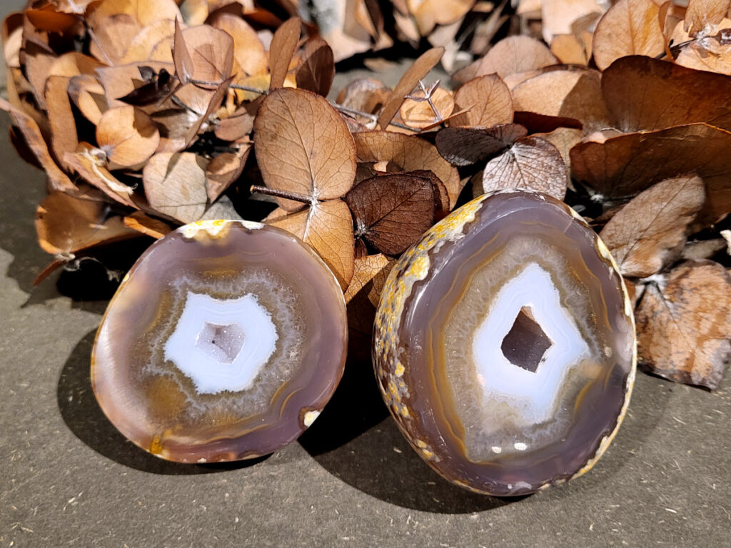 <strong>Agaat, paar, 0,5kg, 24,- euro, agaatschijf, nr. 1</strong>

<strong>Beschrijving Agaat.</strong>

Agaat is een veelzijdige edelsteen die bekend staat om zijn prachtige kleurbanden en patronen. Het is een variëteit van het mineraal kwarts, meer specifiek chalcedoon, en wordt vaak gebruikt in sieraden en als decoratieve steen. 
<strong>Algemene kenmerken:</strong>
Agaat is een microkristallijne vorm van kwarts, bestaande uit microscopisch kleine kristallen. 
<strong>Kleuren en patronen:</strong>
Agaat komt voor in vele kleuren, vaak met banden of lagen in verschillende tinten. 
Agaat is een populaire keuze voor het maken van kettingen, armbanden, ringen en andere sieraden vanwege de esthetische aantrekkingskracht en duurzaamheid. 
<strong>Spirituele eigenschappen:</strong>
Agaat wordt vaak geassocieerd met aardende, stabiliserende en beschermende eigenschappen. 
<strong>Helende werking:</strong>
Er wordt aangenomen dat agaat kan helpen bij het verminderen van stress, het bevorderen van emotioneel evenwicht en het versterken van het zelfvertrouwen. 
<strong>Verzorging van agaat:</strong>
Agaat is relatief gemakkelijk te onderhouden. Het kan worden gereinigd met lauw water, de rook van witte salie of palo santo, of door het op een hematiet- of bergkristal-cluster te plaatsen. 

<strong>-	Kunstgalerie-Arnold -</strong>