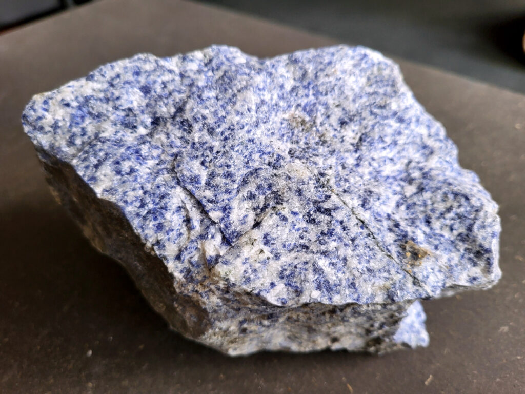 <strong>Sodaliet, ruw, 1,6 kg, 11,- euro, nr. 11,

Sodaliet, beschrijving,
Sodaliet is een diepblauwe edelsteen en mineraal, bekend om zijn helderheid, spirituele betekenis en helende eigenschappen.
Sodaliet is een natrium-aluminiumsilicaat dat behoort tot de veldspaatmineralen en vaak witte aders of vlekken bevat, hoewel de mooiste kwaliteit inktblauw en zonder aders is (Sodaliet kan ook groen, rood of roze zijn afhankelijk van de samenstelling) . De steen heeft een hardheid van ongeveer 5,5–6 op de schaal van Mohs, een glasachtige tot matte glans en een gemiddelde dichtheid van 2,3–2,4 g/cm³. De naam sodaliet is afgeleid van het Engelse sodium (natrium) en het Griekse lithos (steen).  
Geschiedenis en gebruik
Sodaliet werd voor het eerst ontdekt in Zuid-Amerika, met name in Chili, en later ook in Brazilië en Uruguay. Het werd al snel populair als edelsteen en decoratief materiaal, gebruikt in sieraden, beeldjes, schalen en zelfs als blauwe verf of oogmake-up in de oudheid  Oude culturen zoals de Egyptenaren, Grieken en Romeinen waardeerden sodaliet om zijn beschermende en concentratie bevorderende eigenschappen . 
Spirituele en helende eigenschappen
Sodaliet staat bekend als de Steen van de Denker en wordt geassocieerd met rationaliteit, objectiviteit, intuïtie en innerlijke waarheid. Het helpt bij het structureren van gedachten, helder communiceren en zelfvertrouwen, en bevordert rust en focus tijdens werk, studie of meditatie  Spiritueel opent sodaliet het derde oogchakra, versterkt intuïtie en ondersteunt inzichtgevende meditaties. De steen wordt ook gebruikt om negatieve energie af te weren en harmonie in groepen te bevorderen. 
Fysieke voordelen
Fysiek kan sodaliet helpen bij keel-, hals- en stembandproblemen, het verlagen van bloeddruk, het ontspannen van nek en schouders, en het ondersteunen van het beenderstelsel en herstel van pezen  Dankzij het natriumgehalte heeft sodaliet ook een desinfecterende werking. 
Toepassingen
Sodaliet wordt vaak gebruikt in sieraden zoals kettingen, ringen en oorbellen, maar ook voor decoratieve objecten, houtsnijwerk en wandbedekking Het past goed bij de sterrenbeelden Boogschutter en Maagd, en kan helpen bij het vinden van focus, richting en zelfvertrouwen. 
Al met al is sodaliet een veelzijdige steen die zowel mentaal, emotioneel, fysiek als spiritueel ondersteuning biedt en geliefd is om zijn schoonheid en krachtige energetische eigenschappen.
</strong>