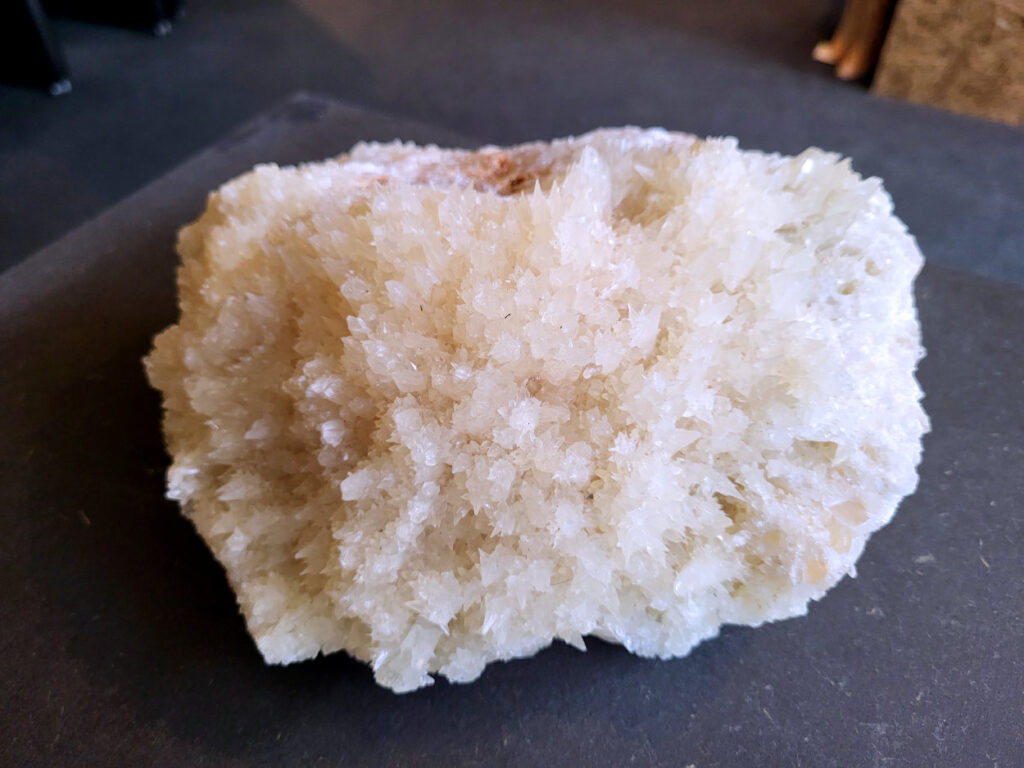 Hondentanden Calciet, 3,1kg, 68,- euro, nr. 5

Hondentandcalciet, beschrijving

Hondentandcalciet, ook wel Starburst calciet genoemd, is een vorm van calciet die bekend staat om zijn unieke, ruwe kristalstructuur die lijkt op hondentanden of varkensstanden. Het wordt gewaardeerd om zijn zachte, heldere uitstraling en wordt vaak gevonden in combinatie met andere mineralen zoals fluoriet. 
Kenmerken van Hondentandcalciet:
Kristalstructuur:
De kristallen zijn grillig, puntig en helder gevormd, wat een ruwe, natuurlijke uitstraling geeft. 
Kleur:
Meestal wit of licht van kleur, soms met bruine tinten of bedekt met andere mineralen zoals fluoriet. 
Energie:
Bekend om zijn zachte, lichtkracht en wordt geassocieerd met diepe transformaties en het openen van het bewustzijn. 
Vormen:
Te vinden in ruwe, onbewerkte vormen, maar ook op standaard of in combinatie met andere mineralen. 
Spiritueel:
Wordt gebruikt voor spirituele doeleinden, zoals meditatie en het openen van het bewustzijn. 
