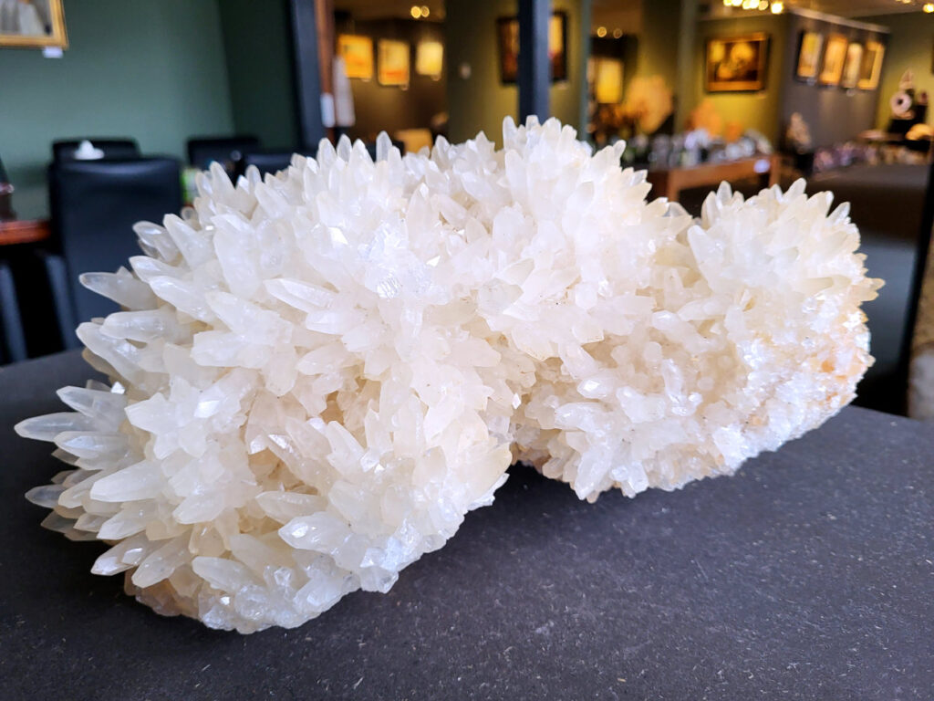 Hondentandencalciet, 8,7 kg, 22x30cm, 185,- euro, nr. 22

Hondentandcalciet, beschrijving

Hondentandcalciet, ook wel Starburst calciet genoemd, is een vorm van calciet die bekend staat om zijn unieke, ruwe kristalstructuur die lijkt op hondentanden of varkensstanden. Het wordt gewaardeerd om zijn zachte, heldere uitstraling en wordt vaak gevonden in combinatie met andere mineralen zoals fluoriet. 
Kenmerken van Hondentandcalciet:
Kristalstructuur:
De kristallen zijn grillig, puntig en helder gevormd, wat een ruwe, natuurlijke uitstraling geeft. 
Kleur:
Meestal wit of licht van kleur, soms met bruine tinten of bedekt met andere mineralen zoals fluoriet. 
Energie:
Bekend om zijn zachte, lichtkracht en wordt geassocieerd met diepe transformaties en het openen van het bewustzijn. 
Vormen:
Te vinden in ruwe, onbewerkte vormen, maar ook op standaard of in combinatie met andere mineralen. 
Spiritueel:
Wordt gebruikt voor spirituele doeleinden, zoals meditatie en het openen van het bewustzijn. 
